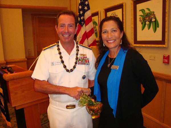 In August, Rear Adm. Paul B. Becker, USN, director for intelligence, U.S. Pacific Command, accepts a token of appreciation from Cynthia Pacheco, chapter president.